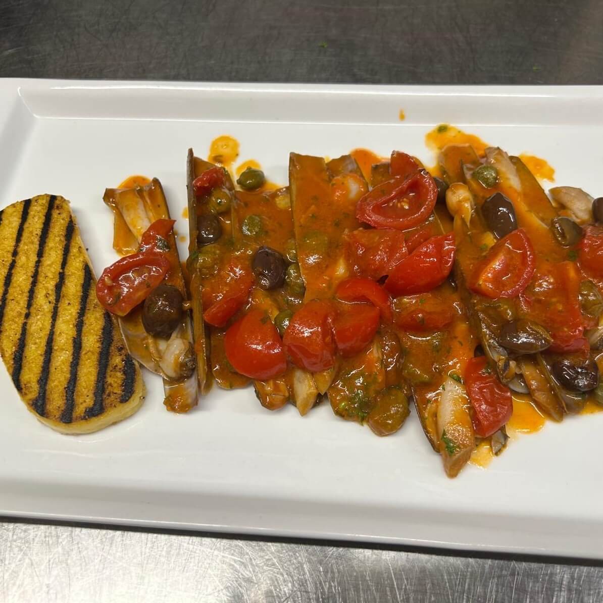 Busara-style sea knives with polenta - Amici Miei | Italian & Mediterranean Food Delivery in Monaco