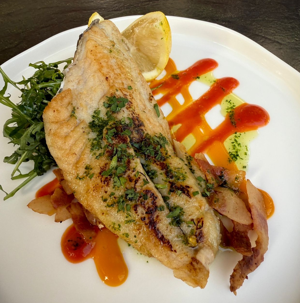 Sea bream fillet with cherry tomato cream, guanciale and spinach - L'Ardoise